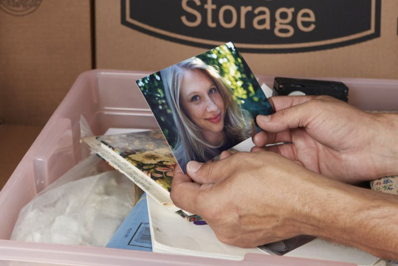 Photos in plastic storage bin 
