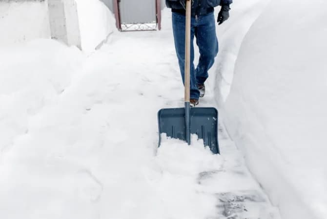 Shoveling snow in a driveway