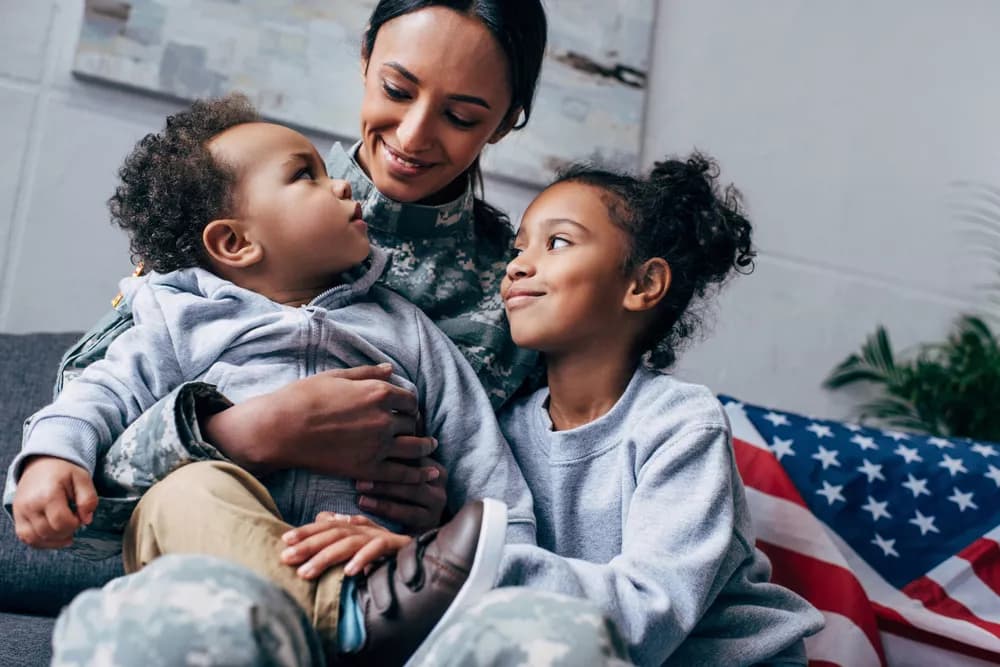 A woman with her kids next to an American flag