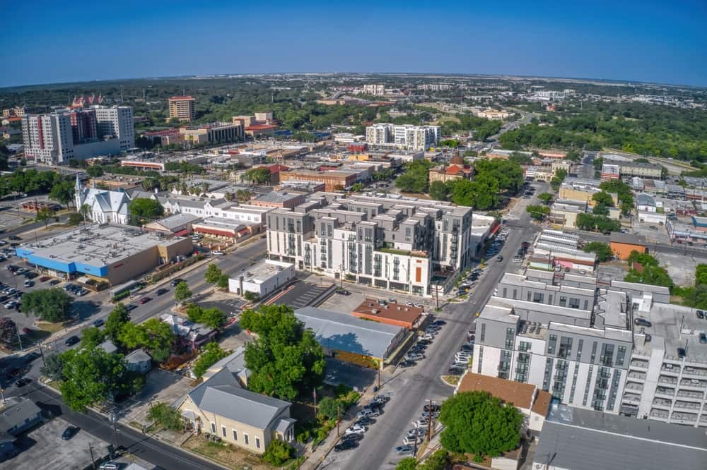 Aerial view of San Marcos, TX during daytime, with blue, cloudless skies.