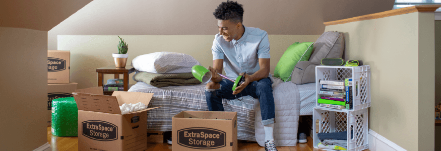 College Student Unpacking Moving Boxes