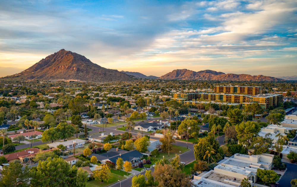 Scenic View of Scottsdale, Arizona featuring residential neighborhoods and mountains in the background at dusk.