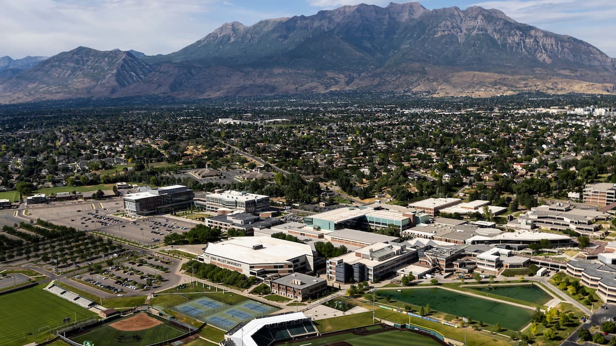 Aerial image of Orem, UT, featuring blue skies and mountains in the background.