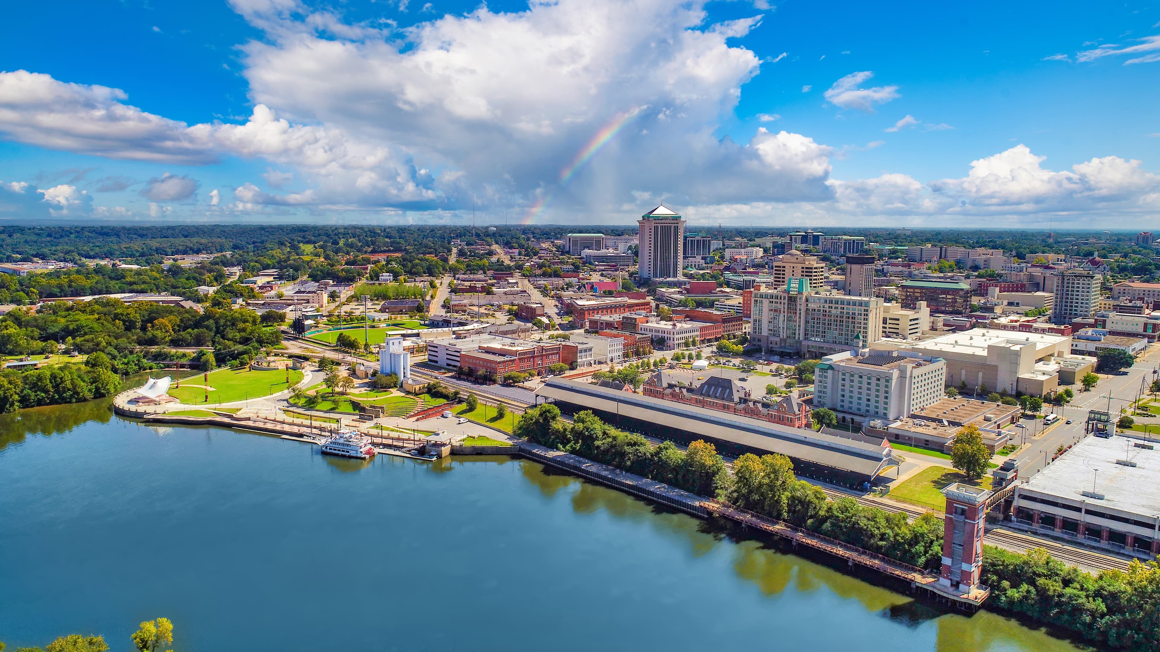 Skyline view of Montgomery, AL during a cloudy day with a rainbow