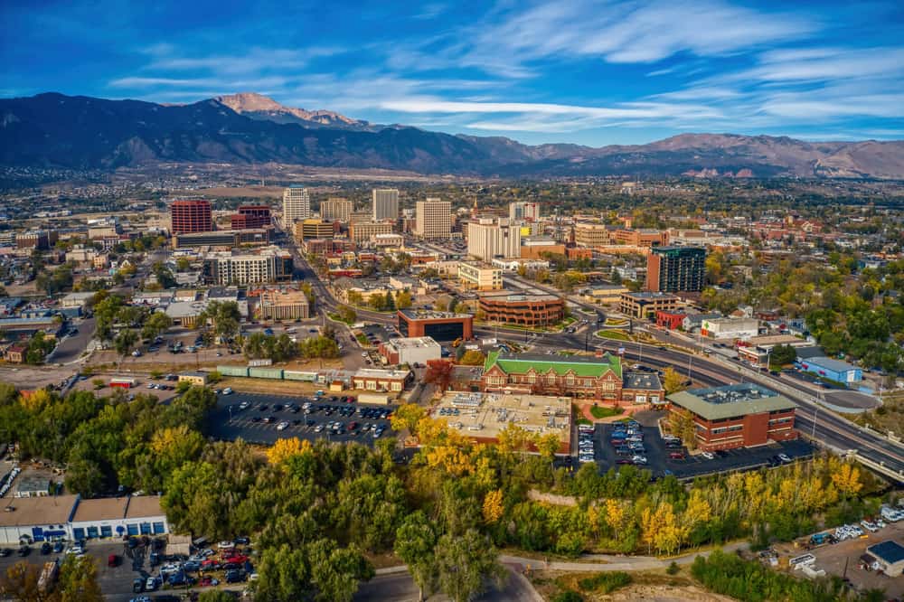 Colorado Springs, Colorado downtown city skyline with mountains on cloudy day