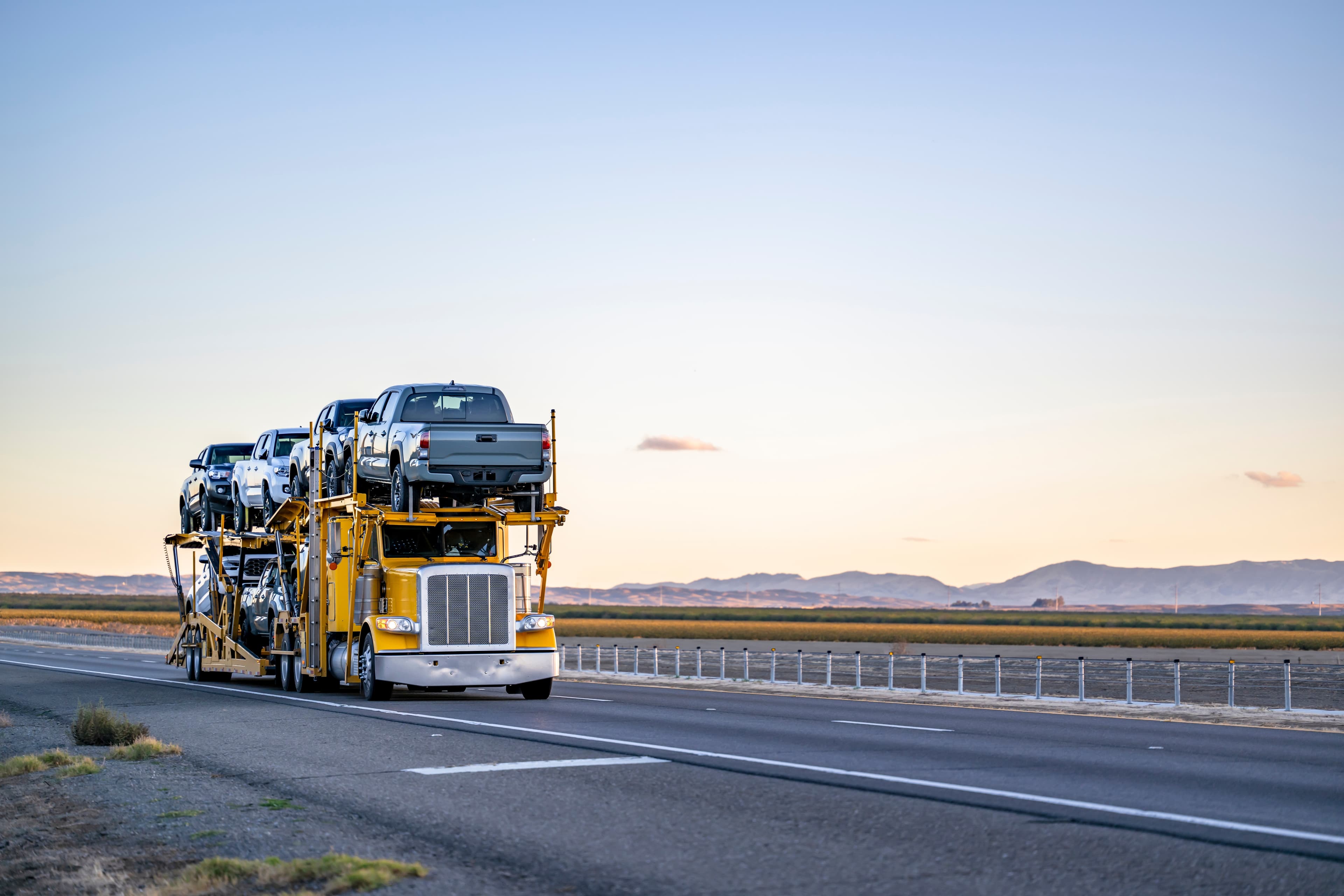 Truck trailer carrying cars on the road