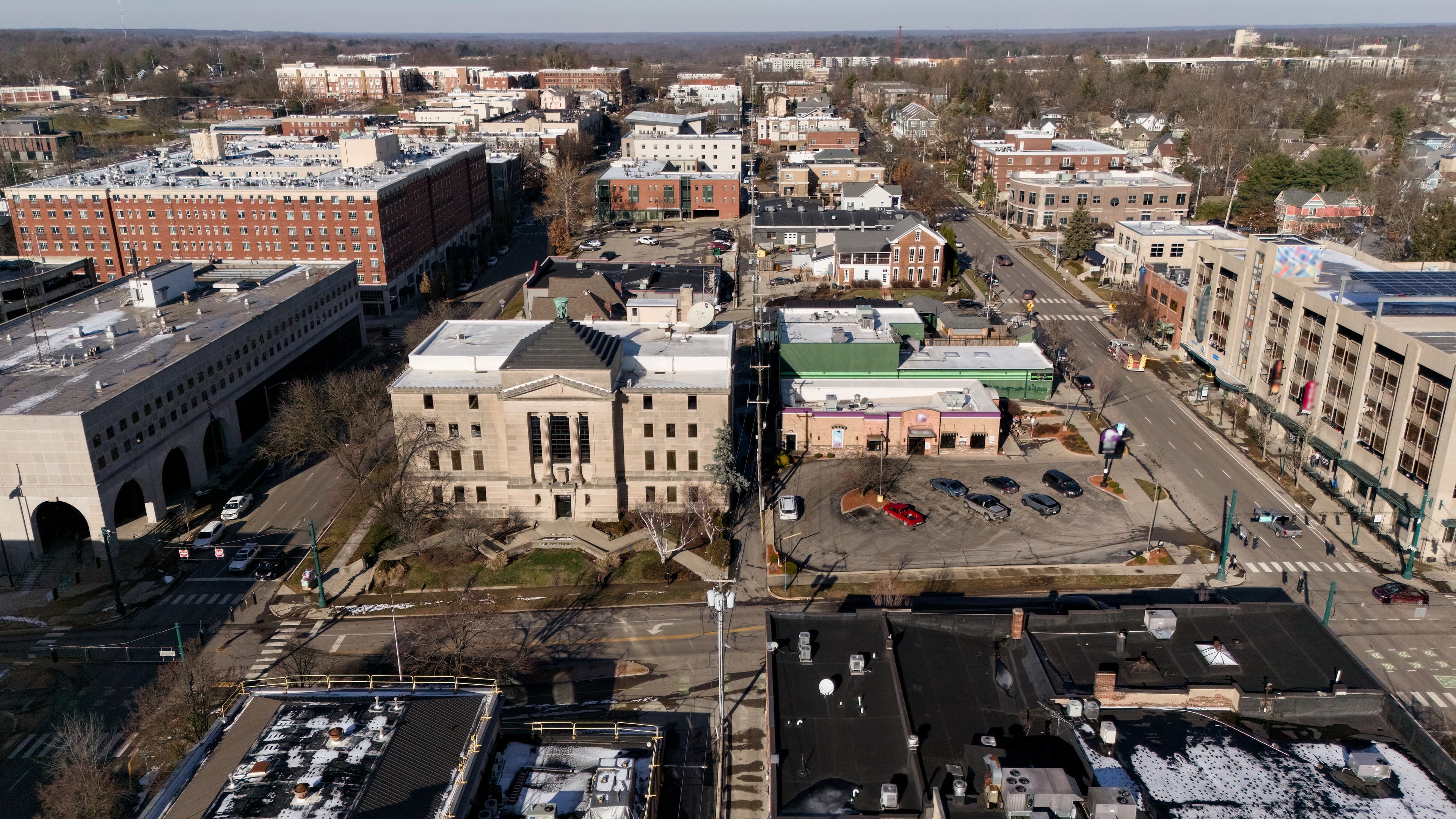 Aerial view of downtown Bloomington, Indiana, featuring streets and mixed-use buildings.