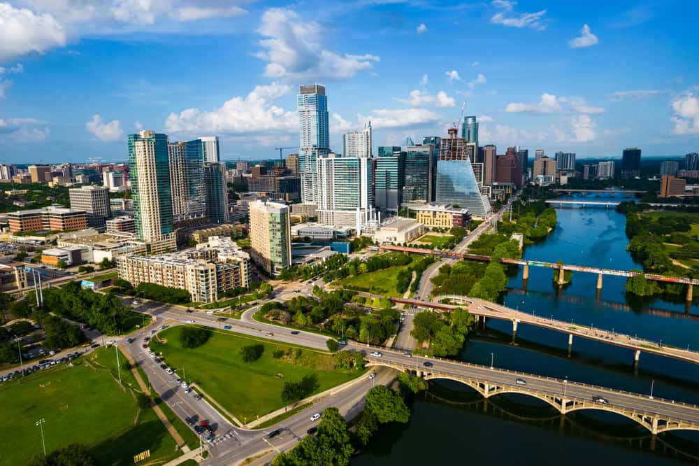 Aerial view of Austin, Texas with bridges, skyscrapers, and Lady Bird Lake on cloudy day