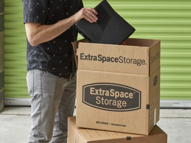 Man packing moving box 