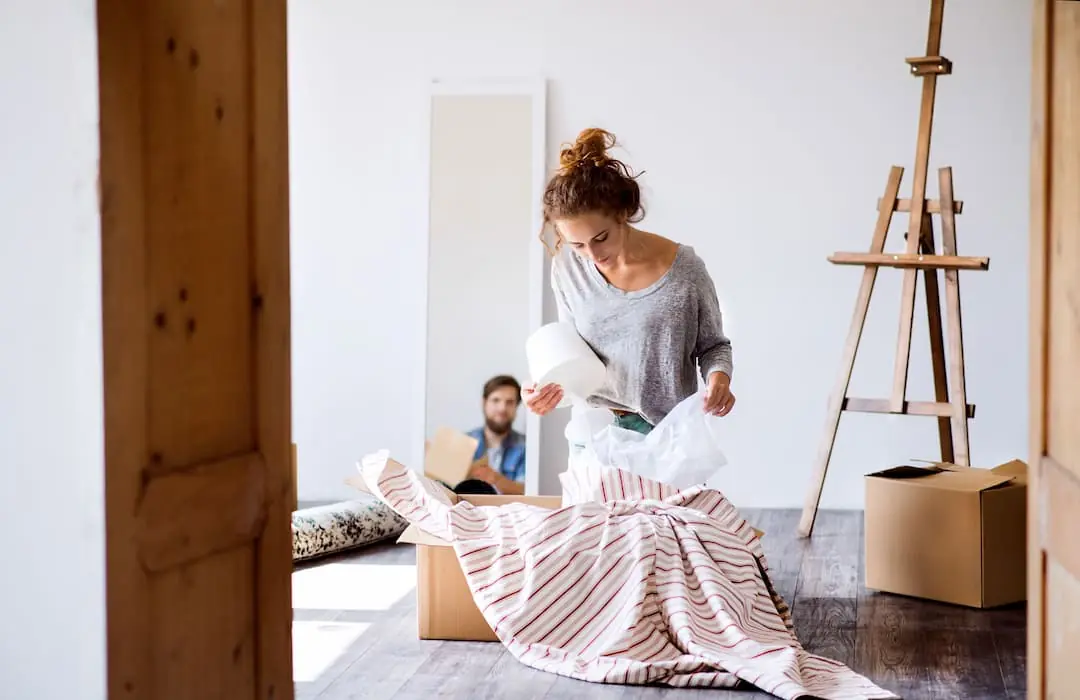 A woman packing a lamp into a box