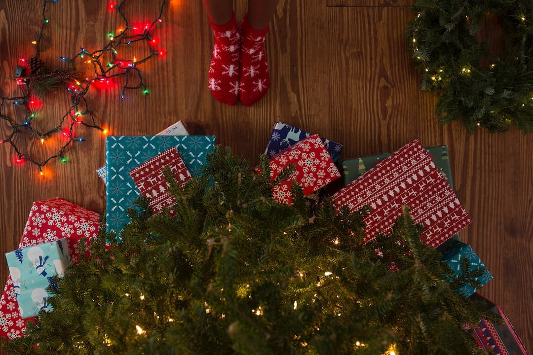 Christmas presents and decorations underneath a Christmas tree.