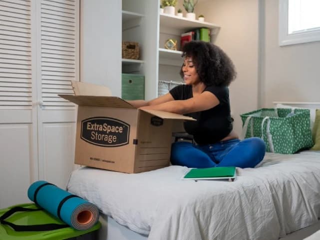 College student packing dorm room