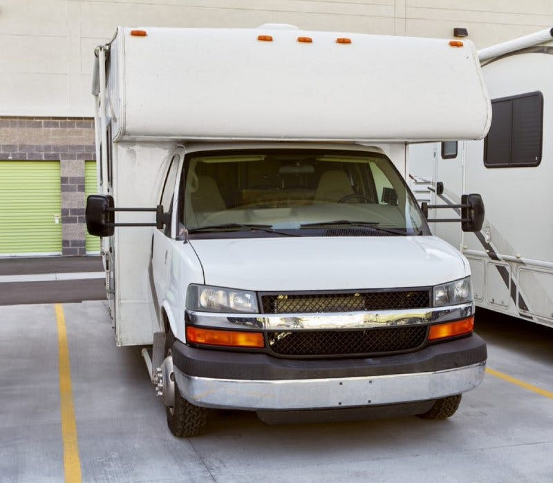 RV camper parked in an outdoor parking stall 