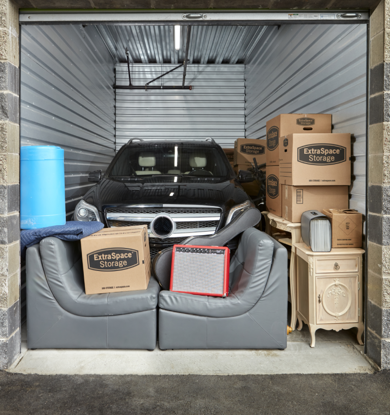 Black SUV inside of a storage unit 