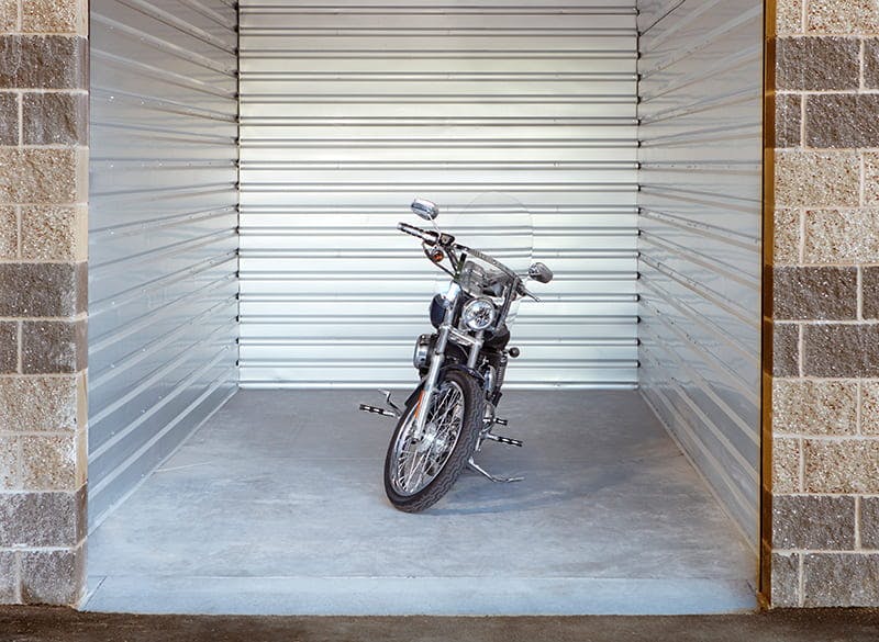 motorcycle sitting inside a storage unit