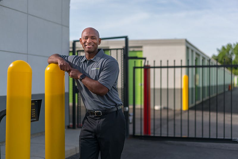 Extra Space Storage employee standing in front of electronic gate 