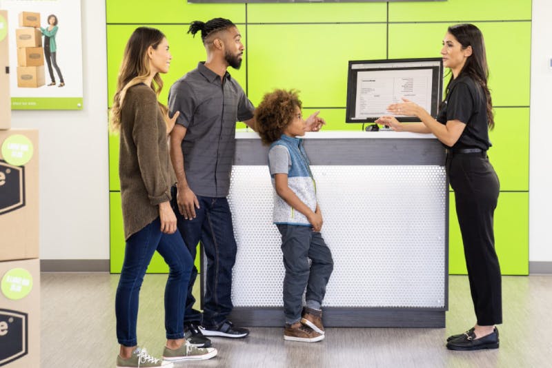 family speaking with Extra Space Storage employee