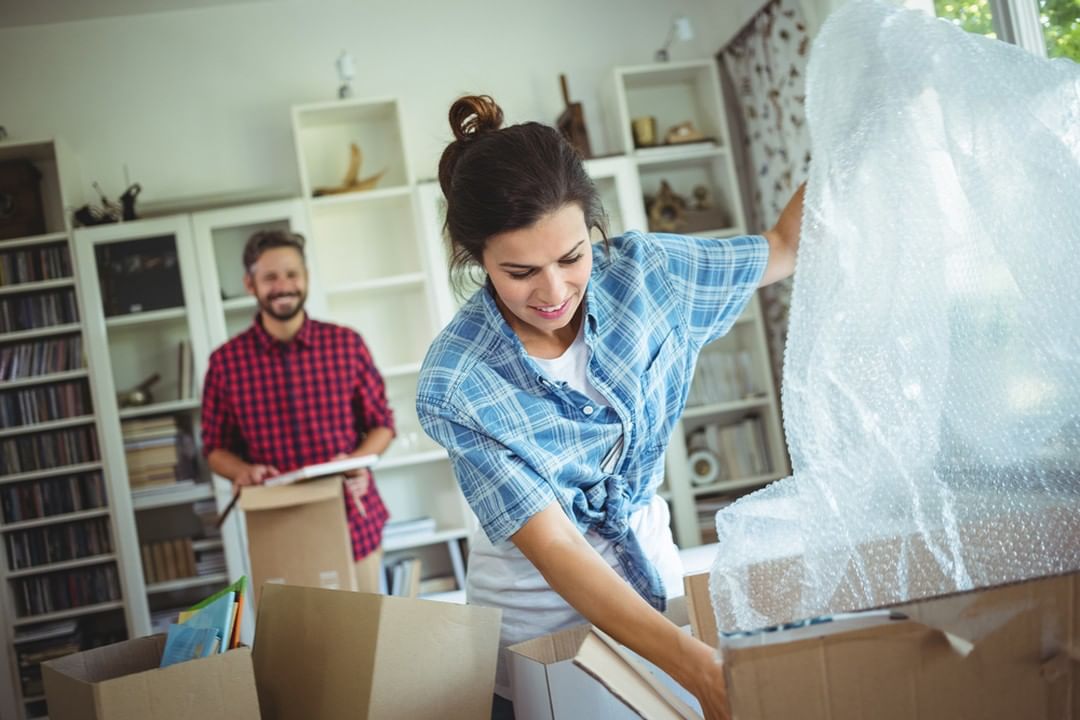 Woman using bubble wrap to pack fragile items. Photo by Instagram user @master_movers