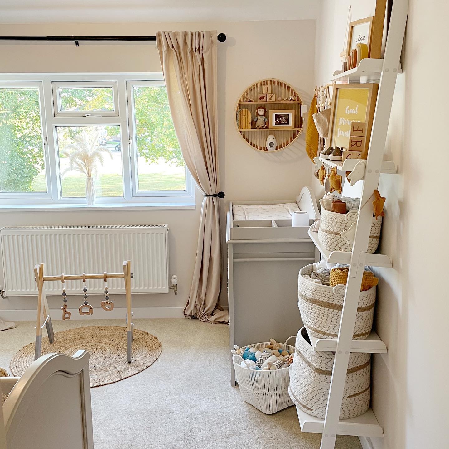 A baby room with a ladder shelf full of items. @thefosterresidence