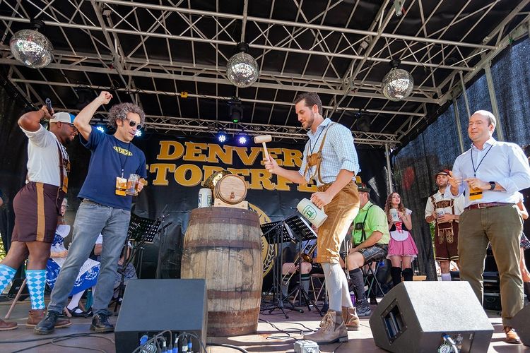 People Celebrating Onstage During Denver Oktoberfest. Photo by Instagram user @denveroktoberfest