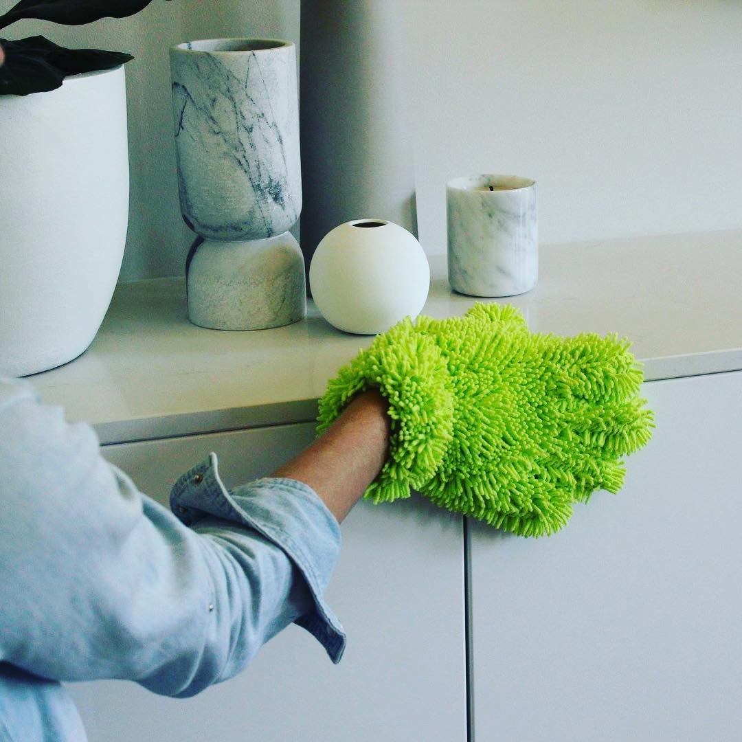 Hand wearing duster cleaning home. Photo by Instagram user @affordable_cleaning_supplies
