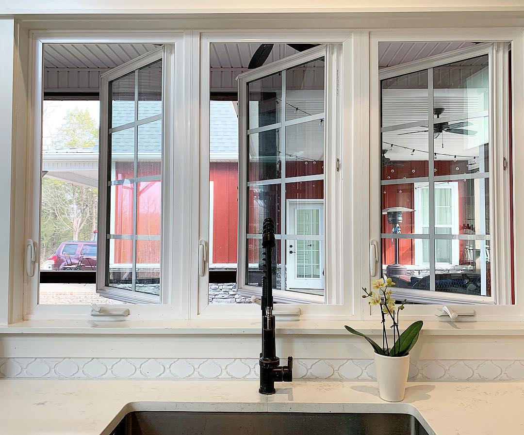 Farmhouse kitchen counter and sink with windows open. Photo by Instagram user @berryfieldacres