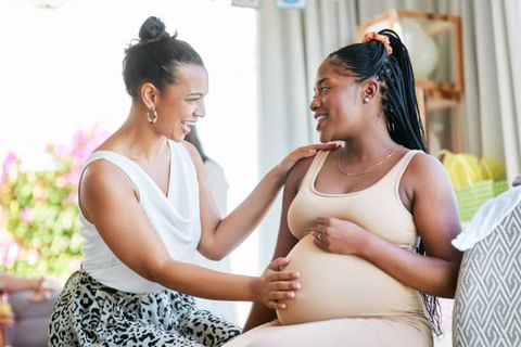 A pregnant woman having a conversation with a friend. Photo by Instagram user @birthrightofmemphis.