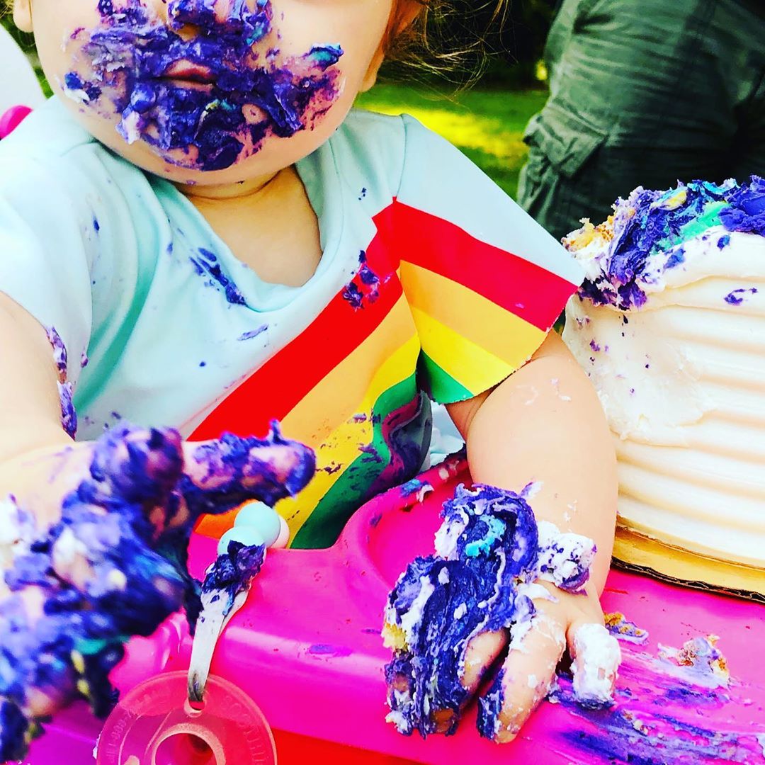 Baby with cake all over face and hands. Photo by Instagram user @sensorytotspot
