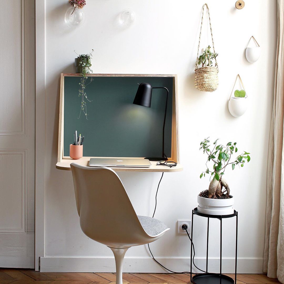 Fold-down desk with computer and chair. Photo by Instagram user @unique.mobilier