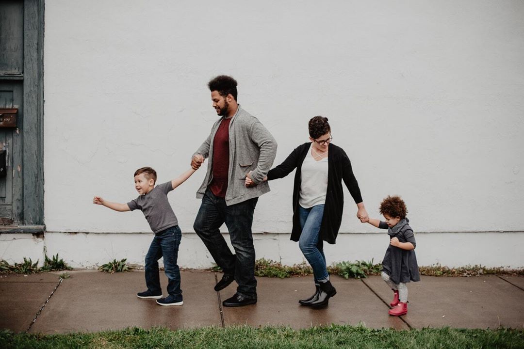 Family walking down sidewalk. Photo by Instagram user @u.santinimovingandstorageny