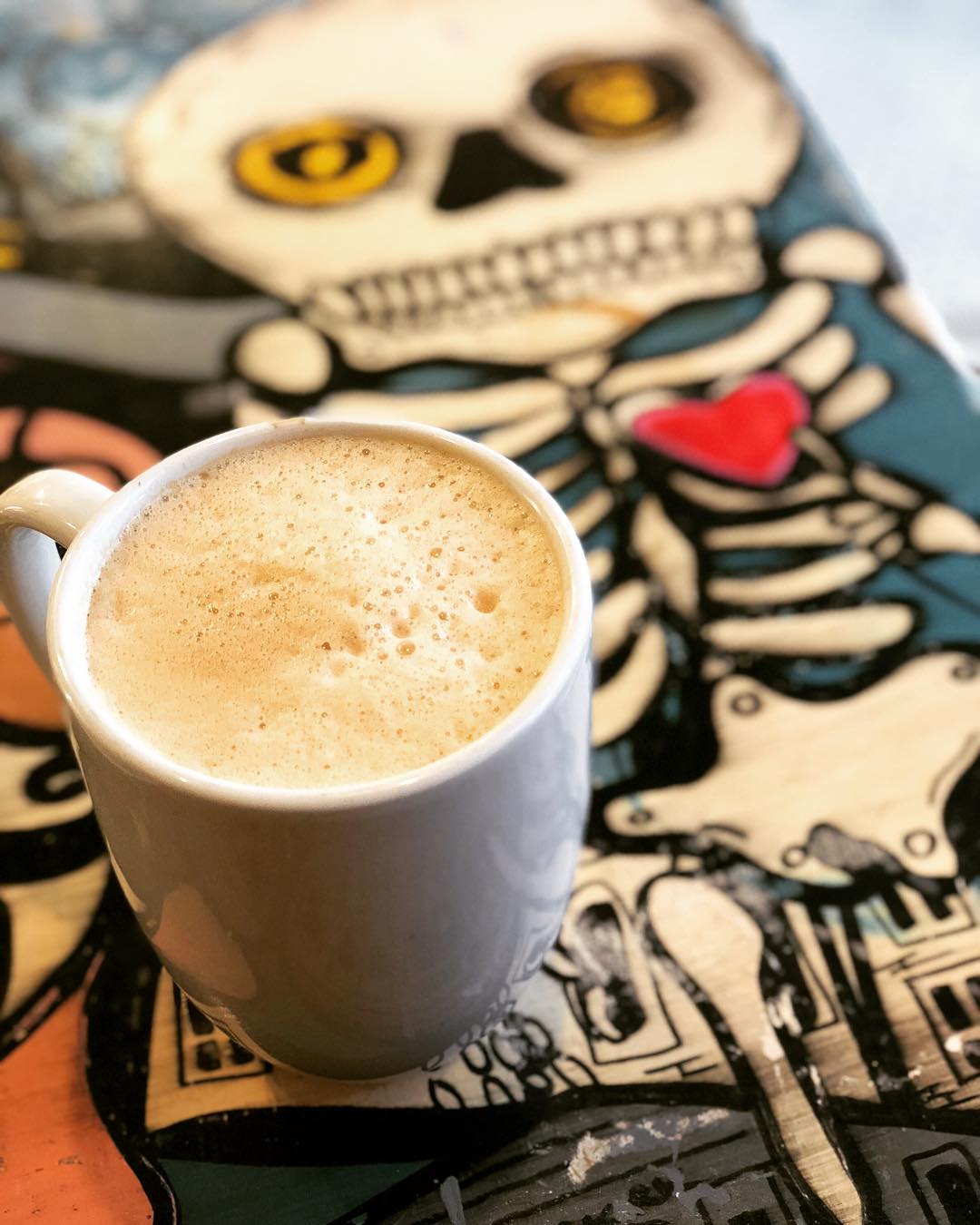 Cup of Coffee on a Table at Cafe Jumping Bean in Chicago. Photo by Instagram user @danielledrinkschicago