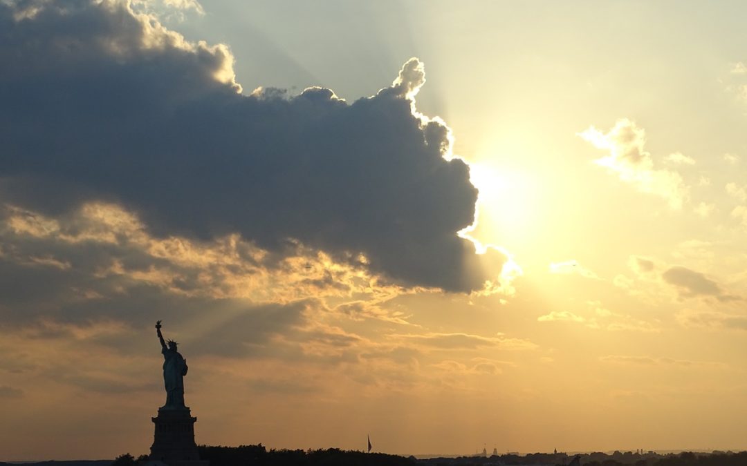 Statue of Liberty from a distance at sunrise