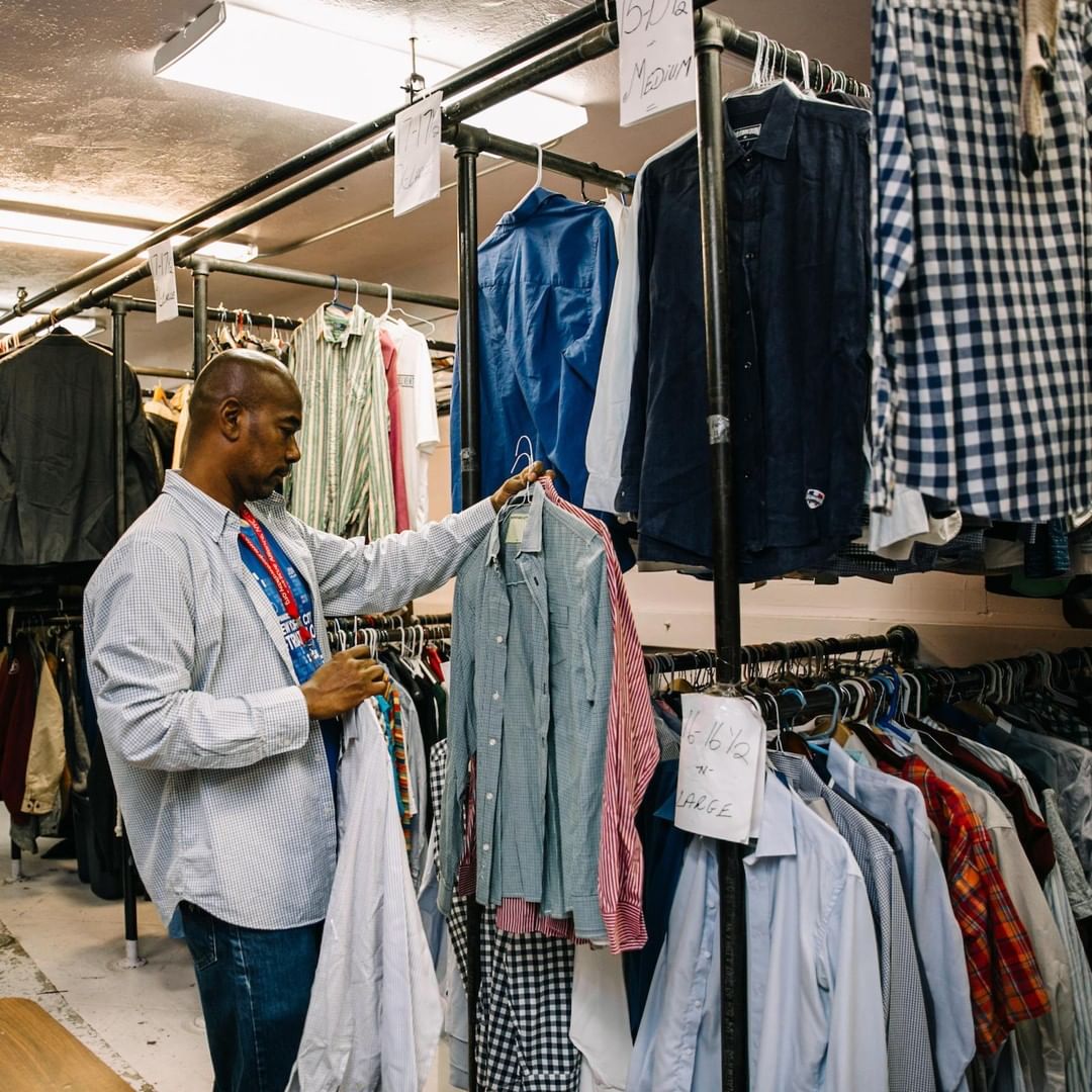 Man Looking Through Donated Clothes on Rack at The Bowery Mission. Photo by Instagram user @bowerymission