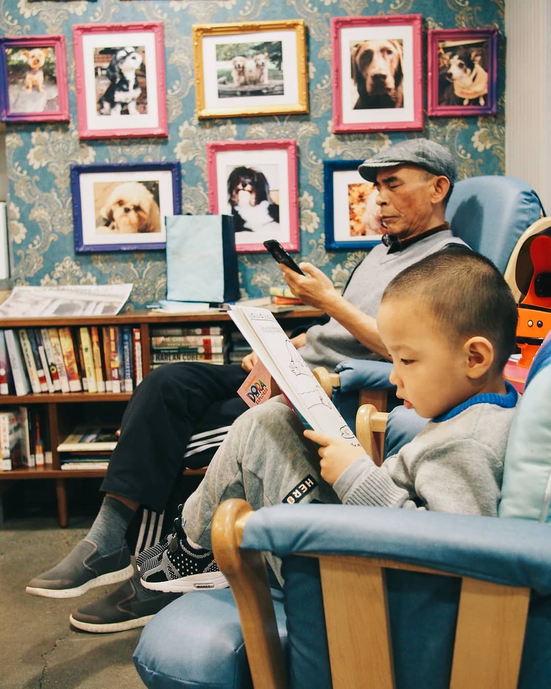 Man and Child Reading in Rocking Chairs at a Ronald McDonald House. Photo by Instagram user @rmhnewyork