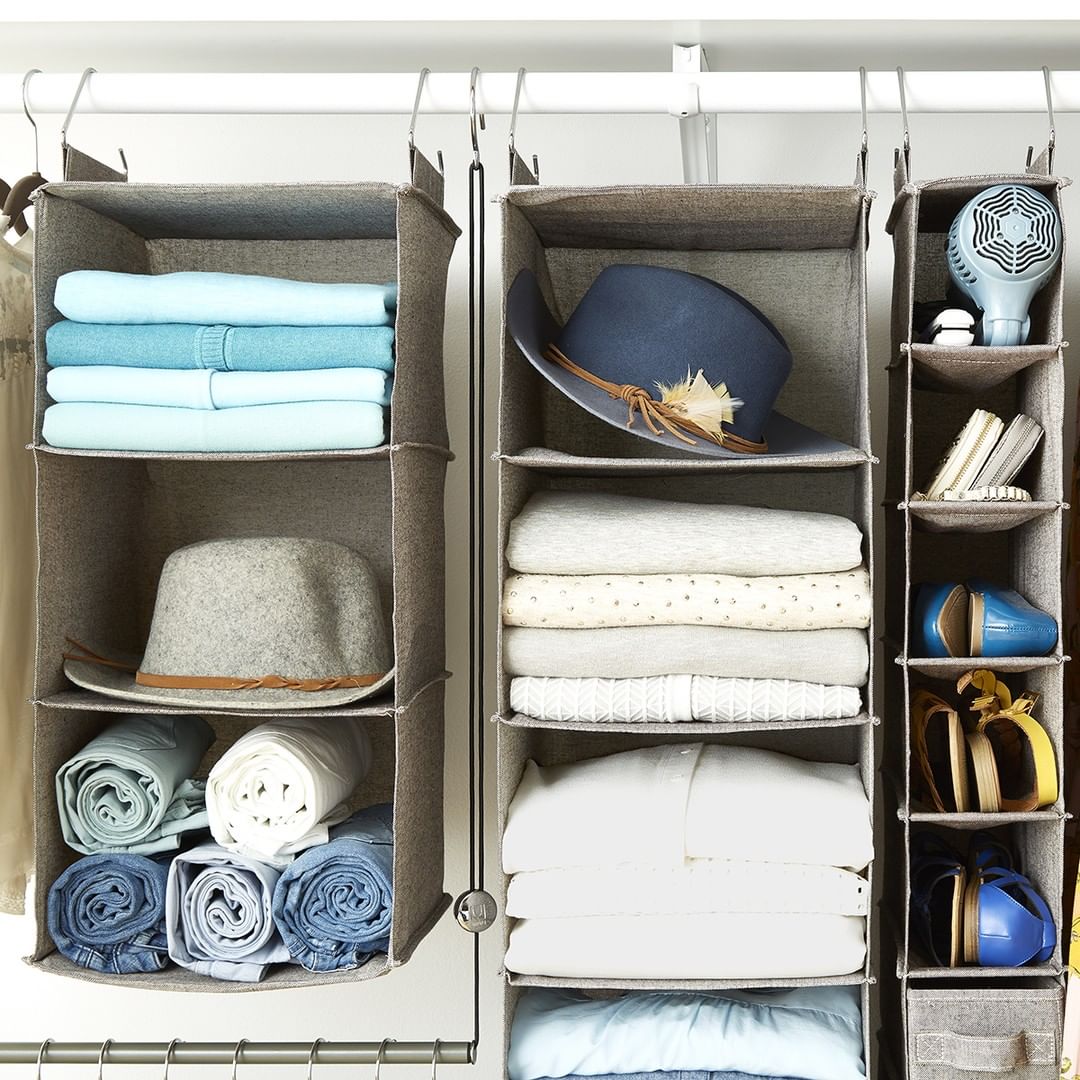 Gray hanging storage filled with hats and shirts. Photo by Instagram user @thecontainerstore