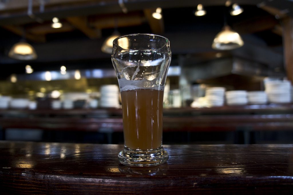 Glass of beer on bar counter