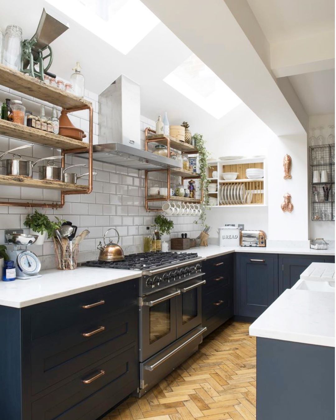 Galley-style kitchen with skylights and plants. Photo by Instagram user @erinthompsonco
