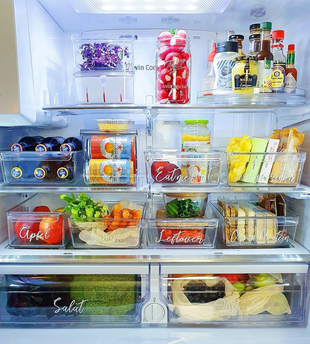 Organized fridge with labeled bins. Photo by Instagram user @thehomehabit