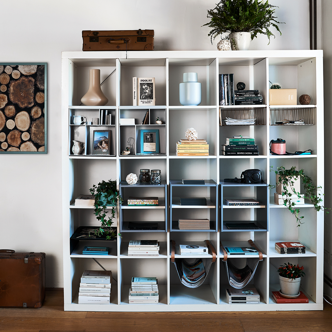 Decor sitting in white cubbie shelves. Photo by Instagram user @ikeafamilymag