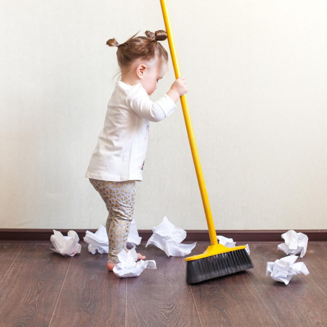 Little girl sweeping papers. Photo by Instagram user @selfsufficientkids