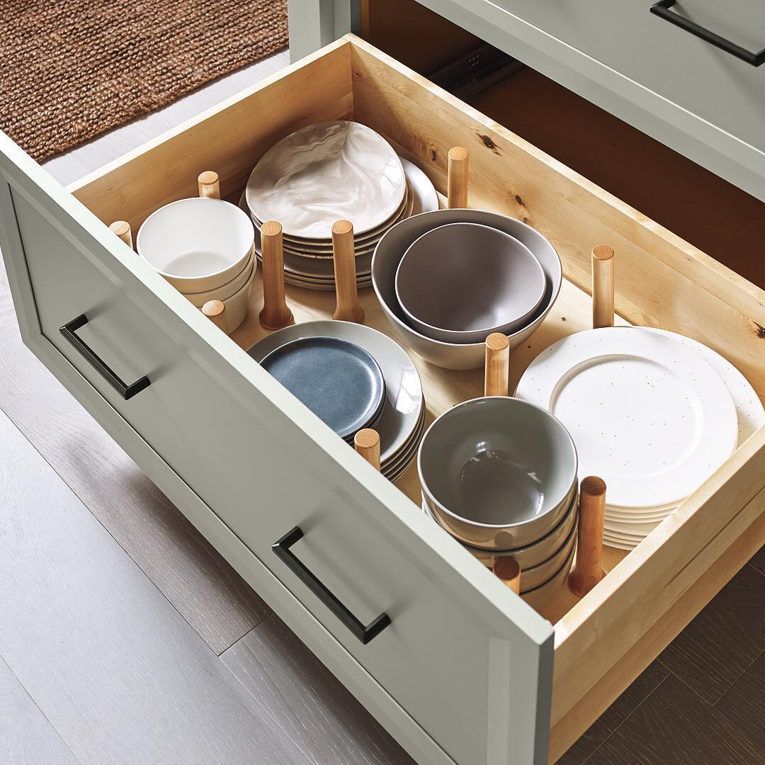 Kitchen drawer with peg organizer for dishes. Photo by Instagram user @masterbrandcabinets