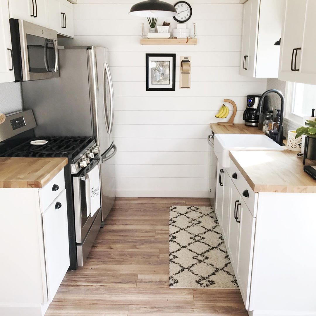 Small galley kitchen with shiplap walls. Photo by Instagram user @kitchstudios