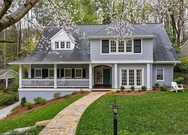 A light blue-gray Craftsman-style home with a green lawn in the Buckhead neighborhood of Atlanta.