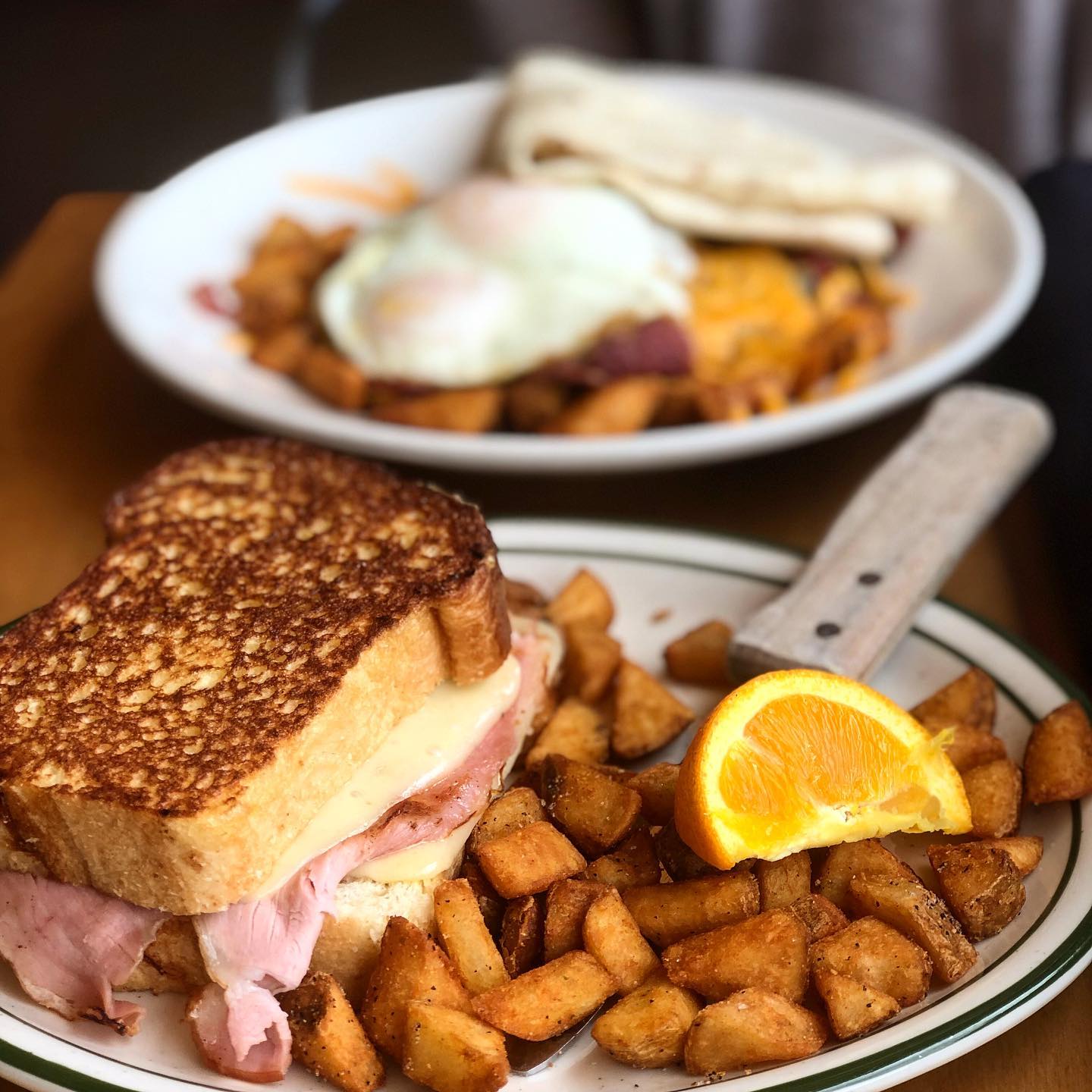 Plate of ptoatos and breakfast sandwich. Photo by Instagram user @wandering_fatties
