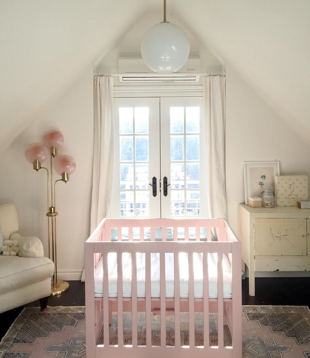nursery with pink crib. Photo by Instagram photographer @hawkeyesdesign