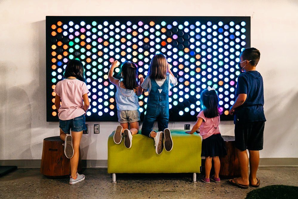 Children playing on interactive light board. Photo by Instagram user @thetechinteractive