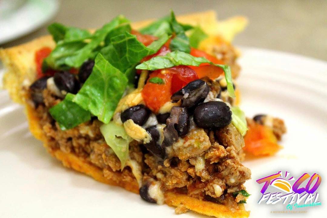 Closeup of taco pie slice on a white plate. Photo by Instagram user @mvblfeast