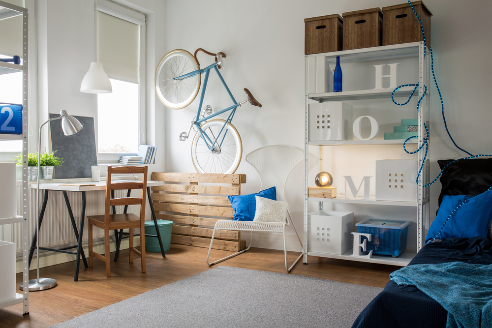 small corner of apartment with bookshelf and desk