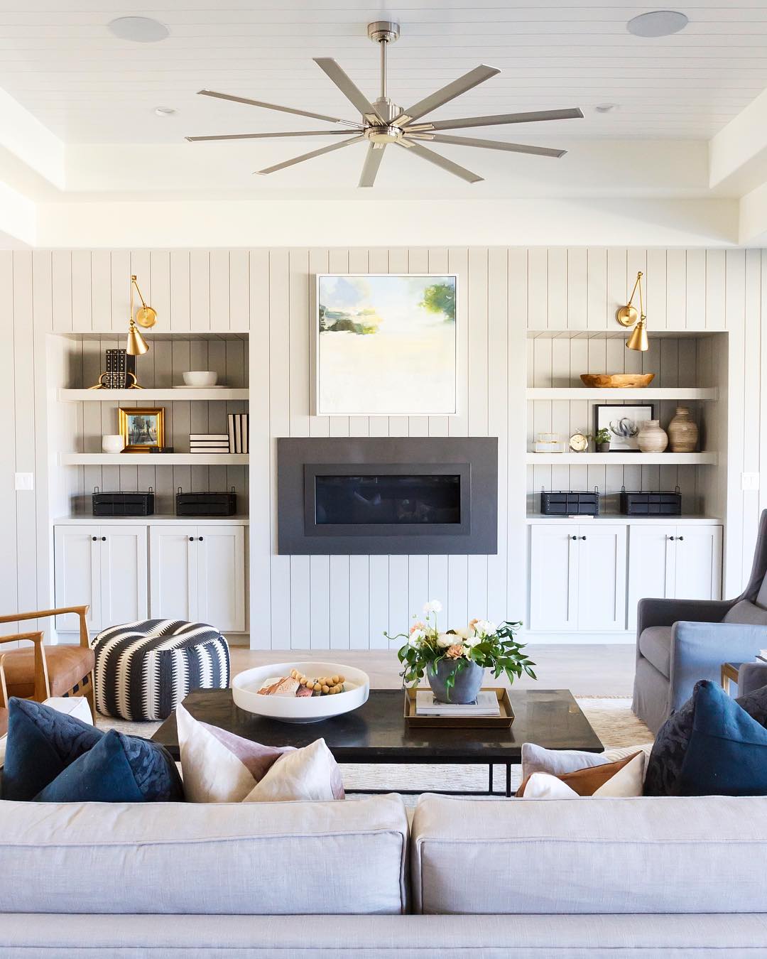 Modern living room with shiplap walls. Photo by Instagram user @saltboxcollective