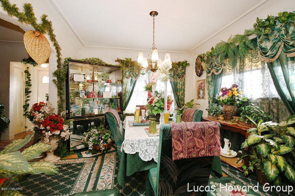 Room cluttered with furniture and plants